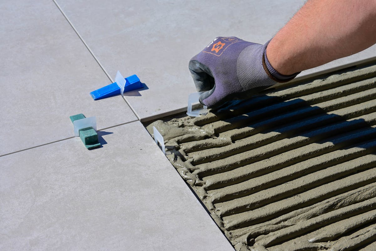 Tile leveling clips and trowel used for precise floor leveling in St George UT